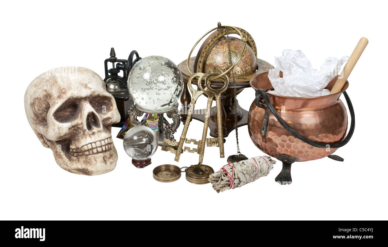 Cluttered witch's corner including copper pot, keys, crystal balls and herbs - path included Stock Photo
