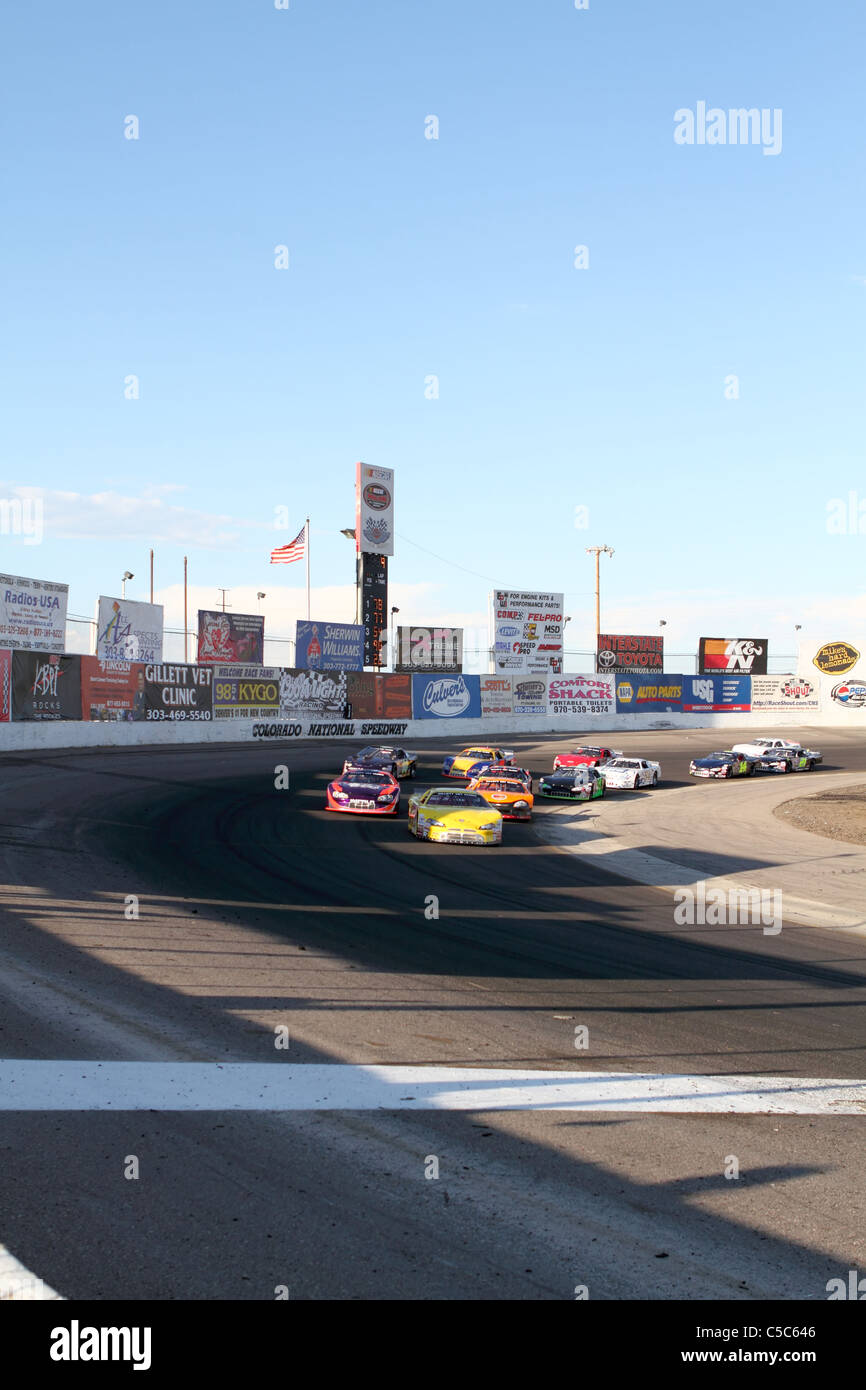 Denver, Colorado A group of Late Model race cars round turn four just