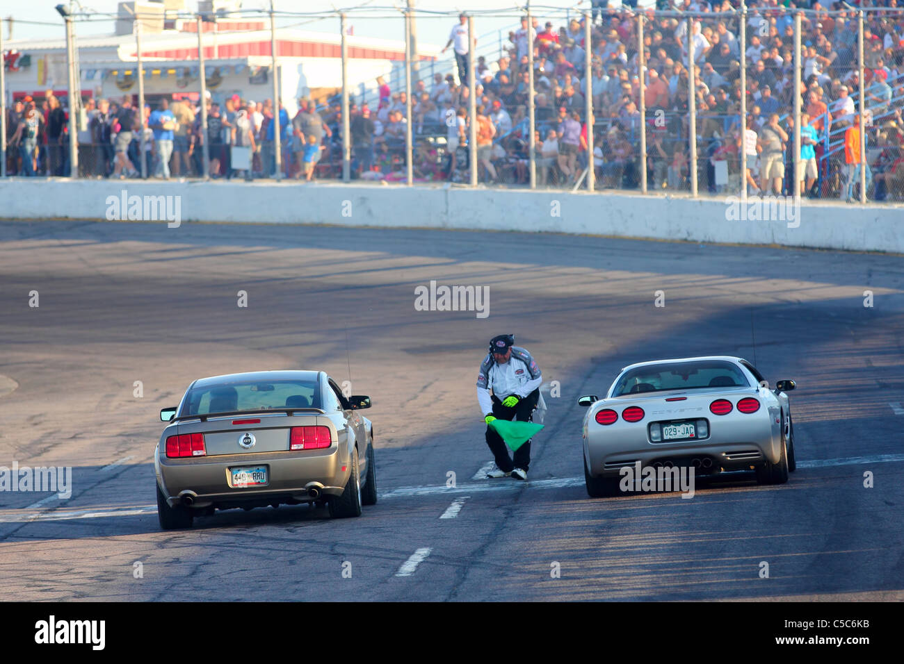 Denver, Colorado - A Ford Mustang and a Chevrolet Corvette are signaled to start the private citizen drag race Stock Photo