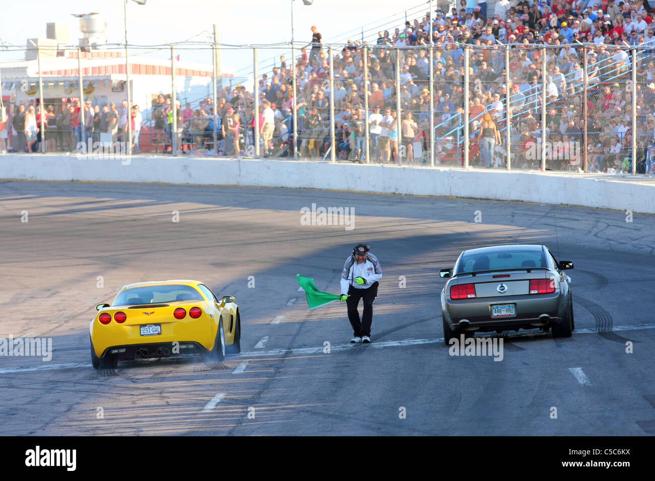 Denver, Colorado - A Ford Mustang and a Chevrolet Corvette are signaled to start the private citizen drag race. Stock Photo