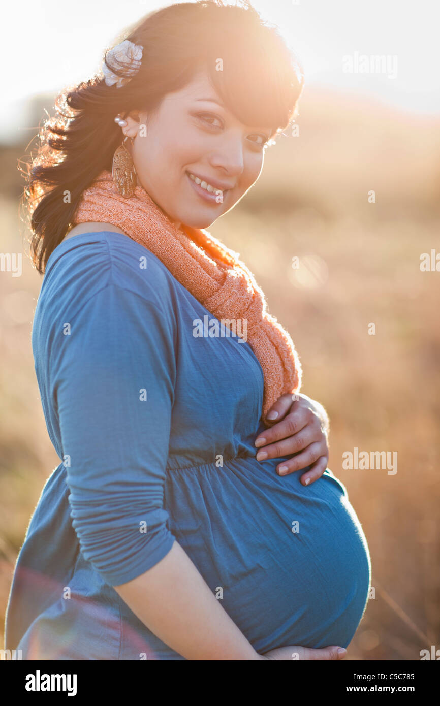 Pregnant mixed race woman holding stomach Stock Photo Alamy