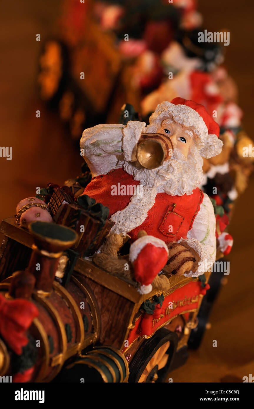 Beautiful wooden Santa figurine sitting on train Stock Photo