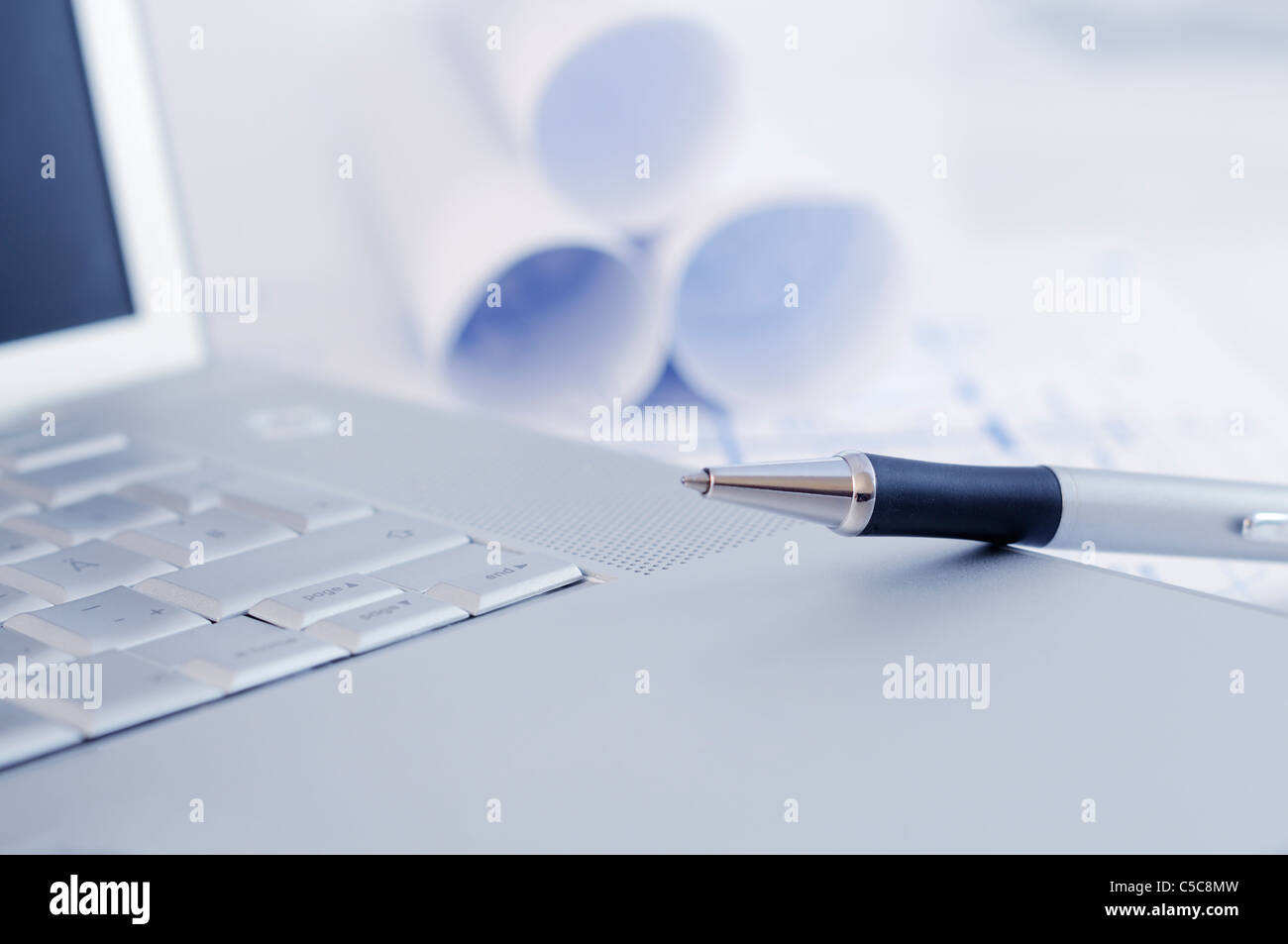 Architectural plan with laptop and silver pen Stock Photo