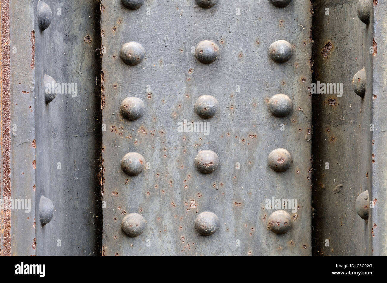 Grungy metal plate background with rivets. Stock Photo