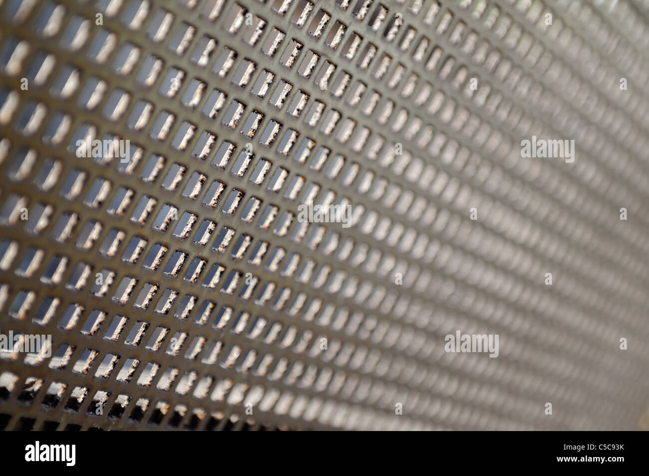 Old metal grid in perspective, short depth of field. Stock Photo