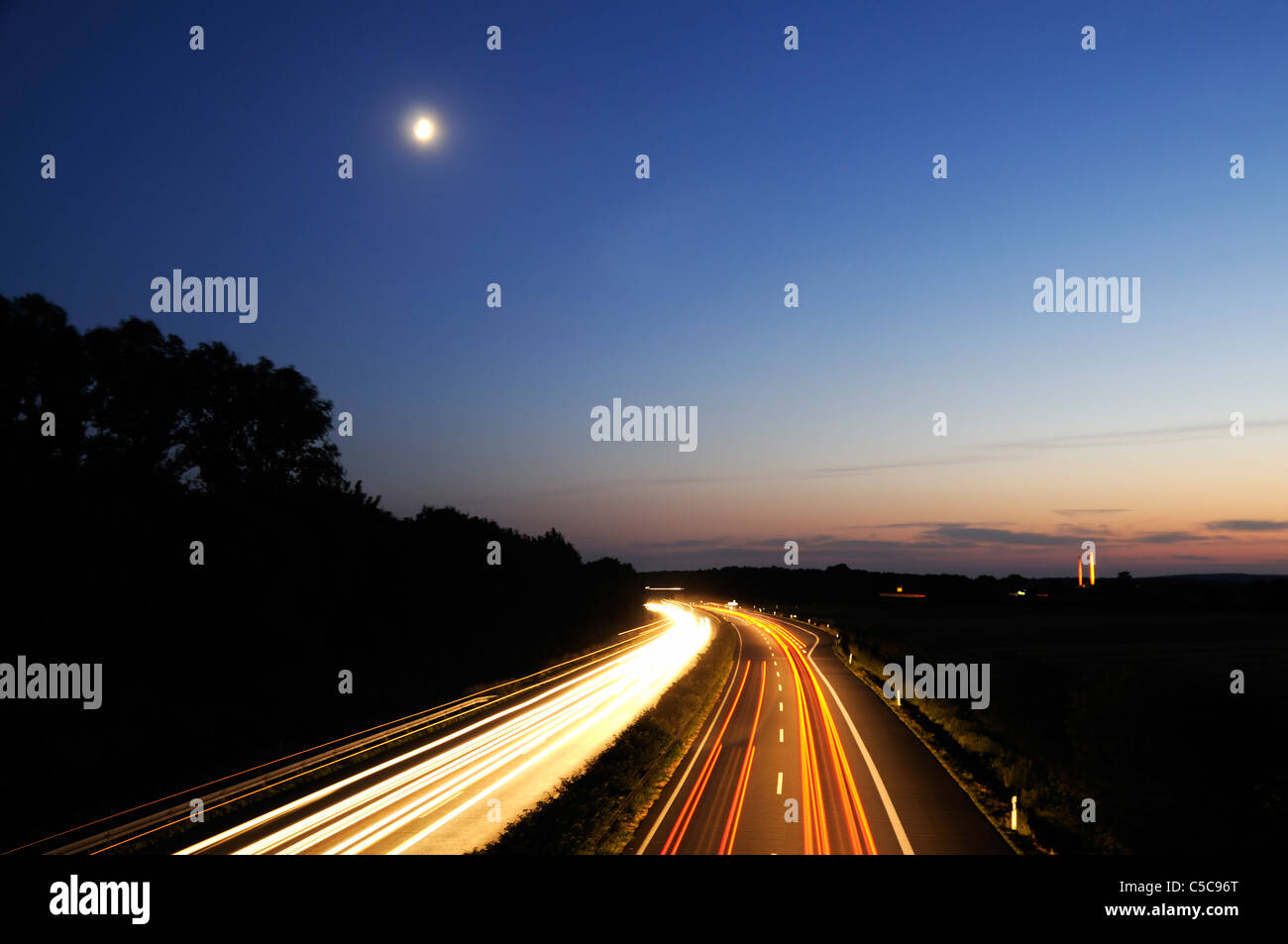Night shot of curve on german autobahn and motion blured car lights - long exposure Stock Photo