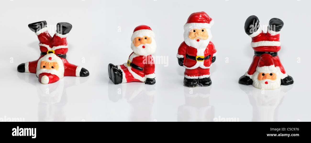 Four funny Santa Clause figurine isolated on white Stock Photo