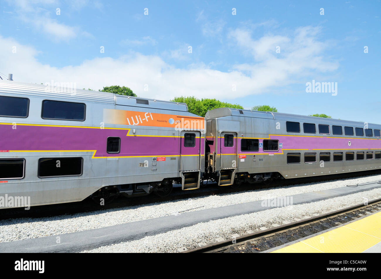 Commuter rail train double decker passenger cars on railroad tracks, USA. Stock Photo