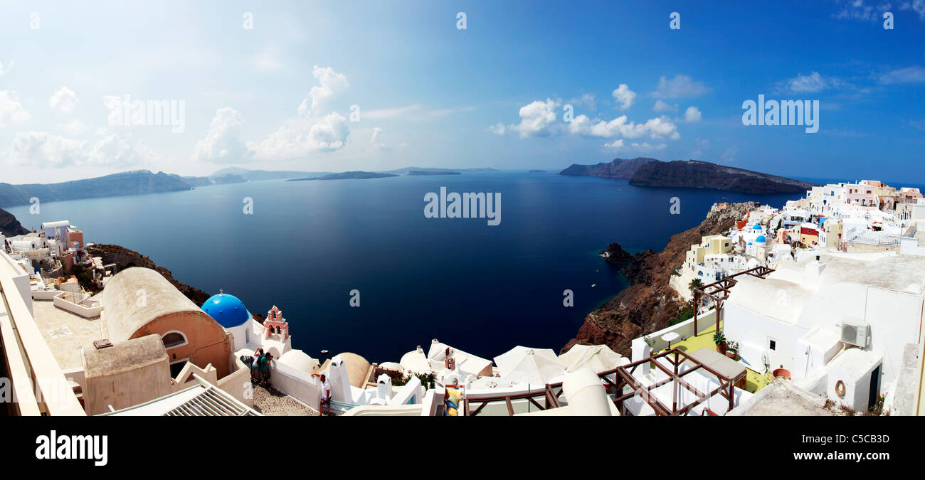 Oia village on Santorini Greek island, panorama panoramic of white washed iconic houses perched on the cliff Stock Photo