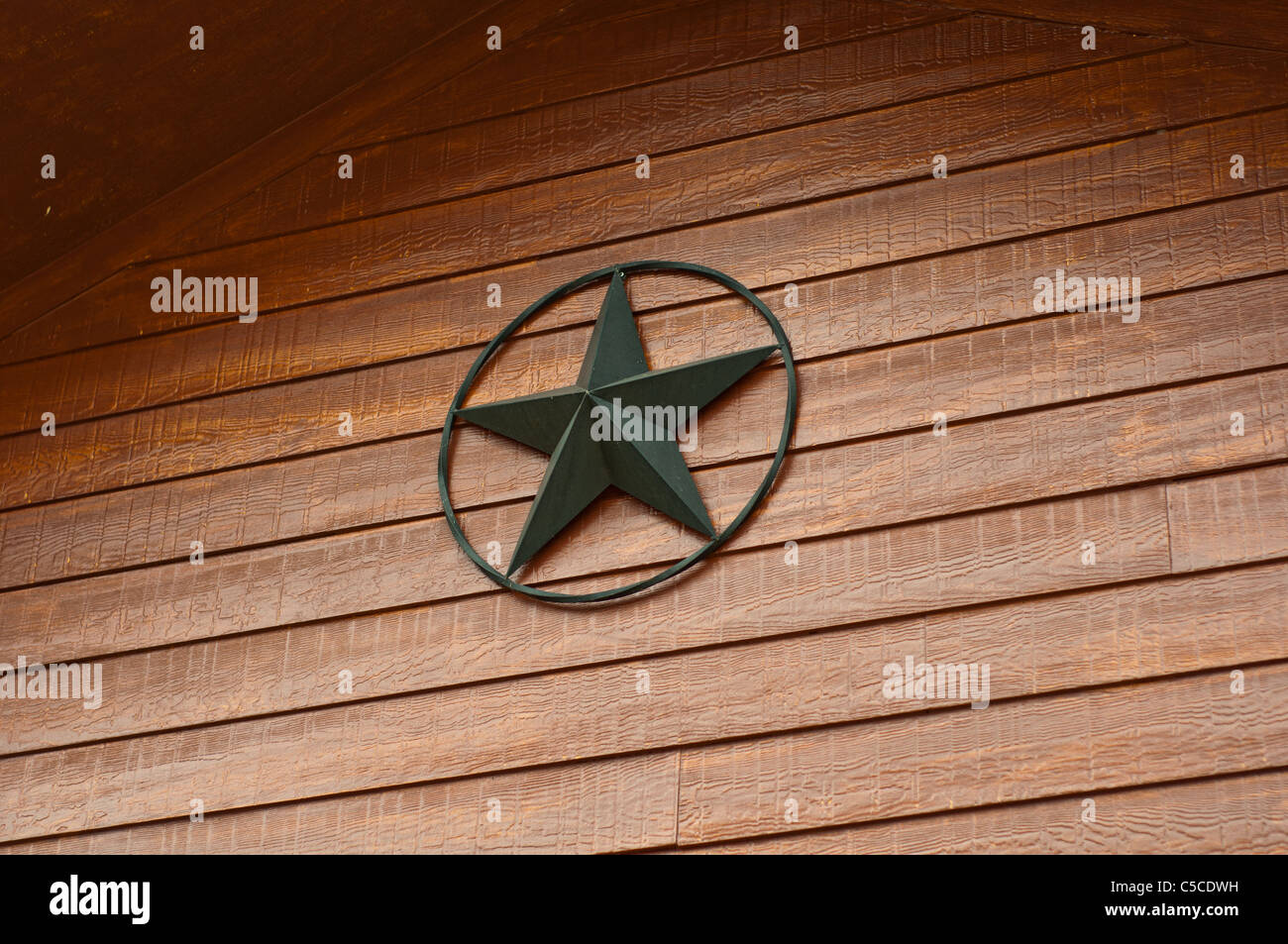 Rustic metal star on wooden house Stock Photo