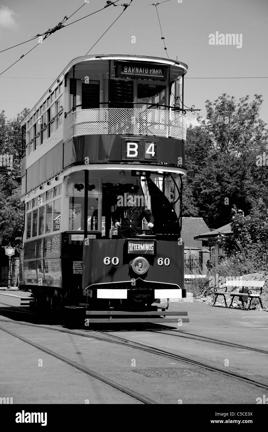 B&W image of a tram running along the tracks at Crich Railway Museum. Stock Photo