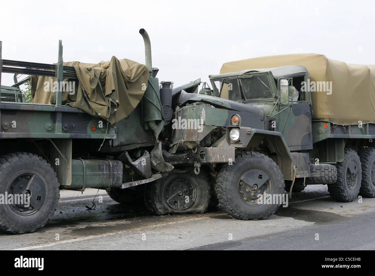 Army trucks in head on collision. Stock Photo