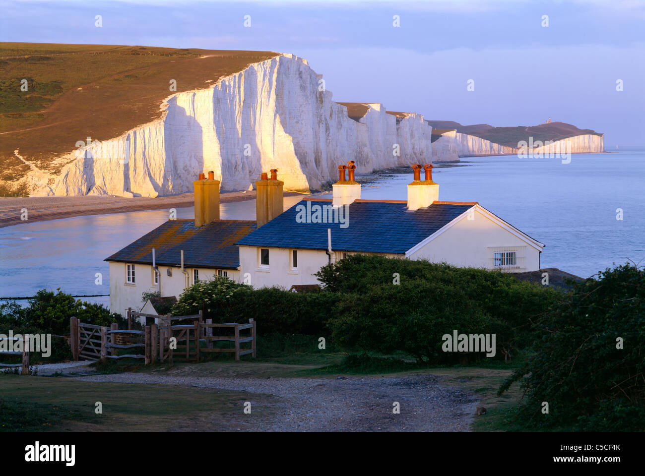 An evening view close to sunset of the Seven Sisters and Coastguard cottages from Seaford Head, East Sussex Stock Photo