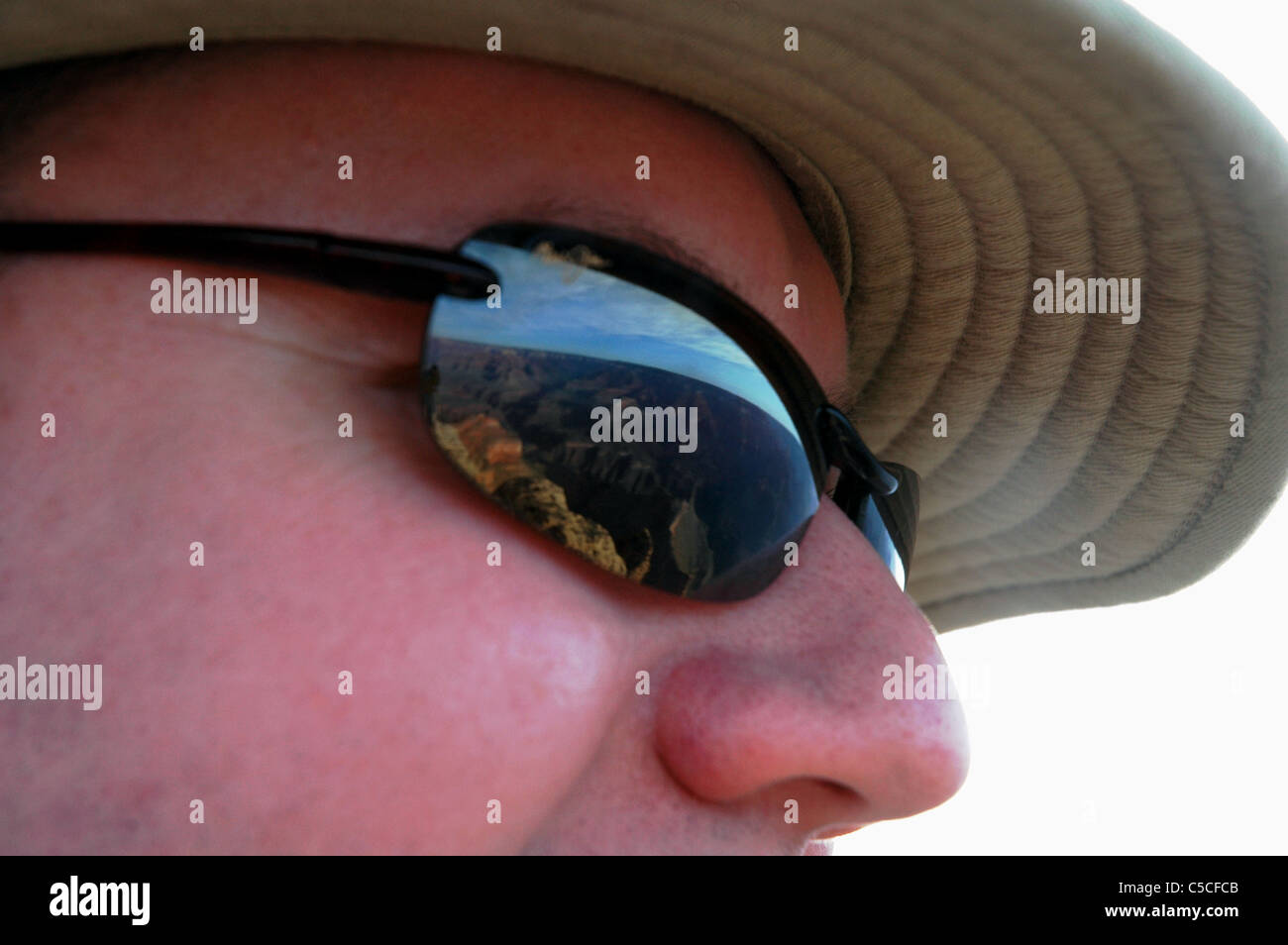 The Grand Canyon is reflected in the lenses of a tourist's sun glasses Stock Photo
