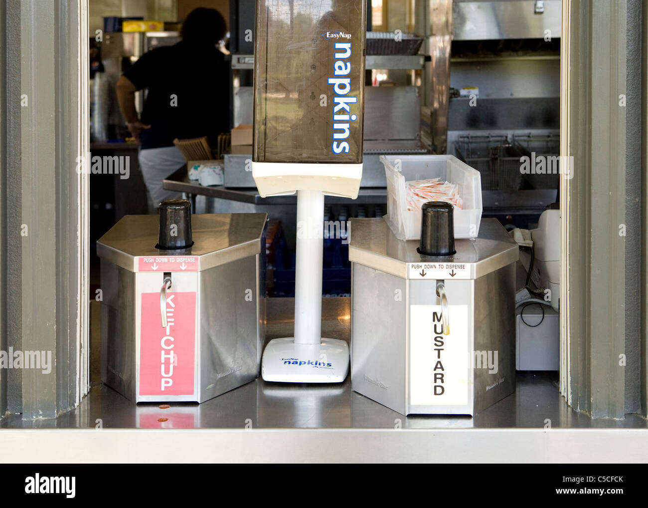 Napkin and condiment dispensers in window Stock Photo