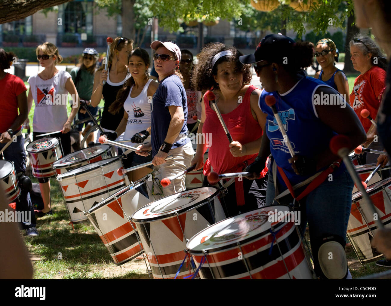 An urban female drum circle performing in park Stock Photo Alamy