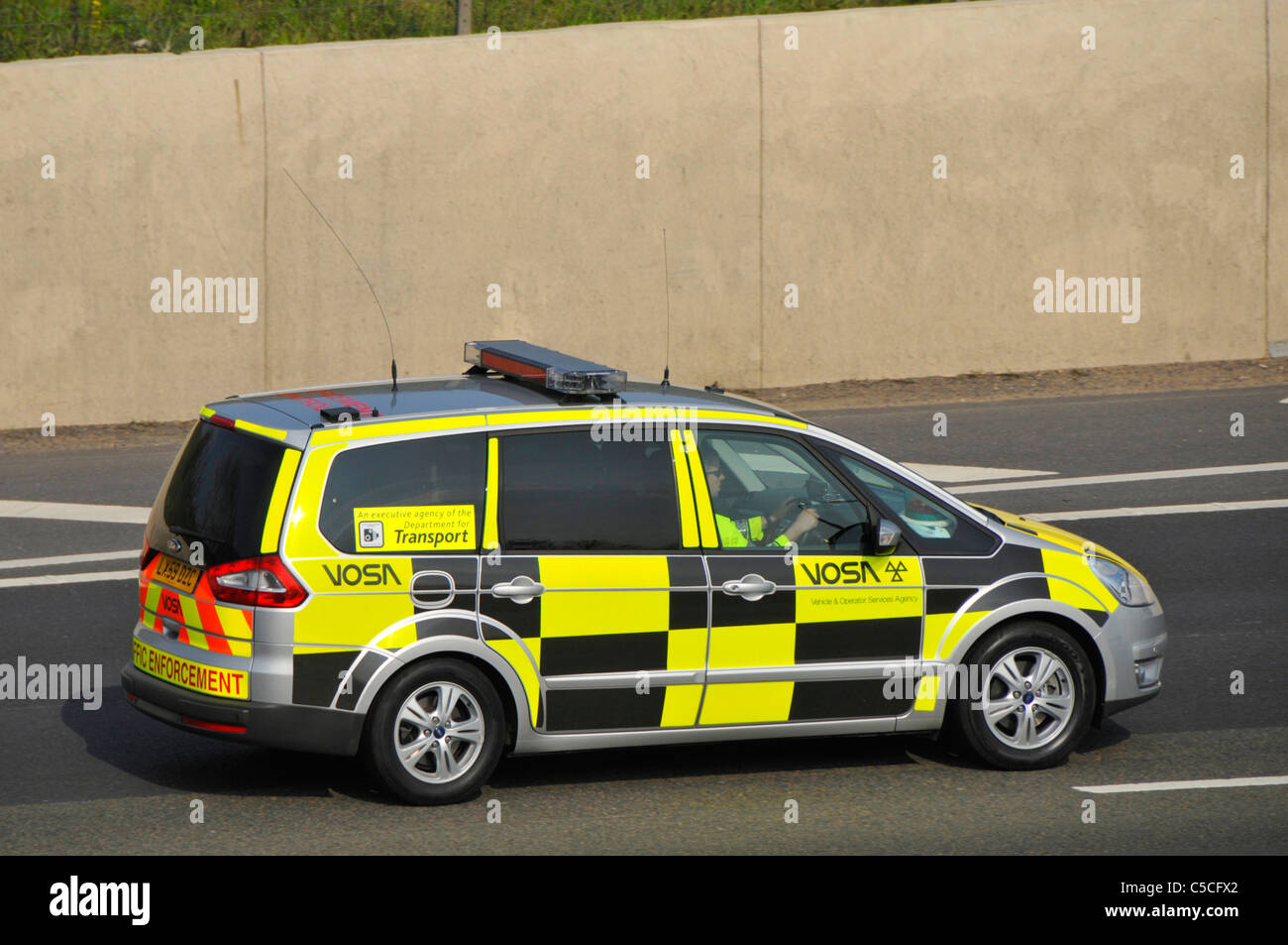 Vehicle & Operator Services Agency Traffic Enforcement Car an executive agency of the Department of Transport driving on M25 motorway Essex England UK Stock Photo