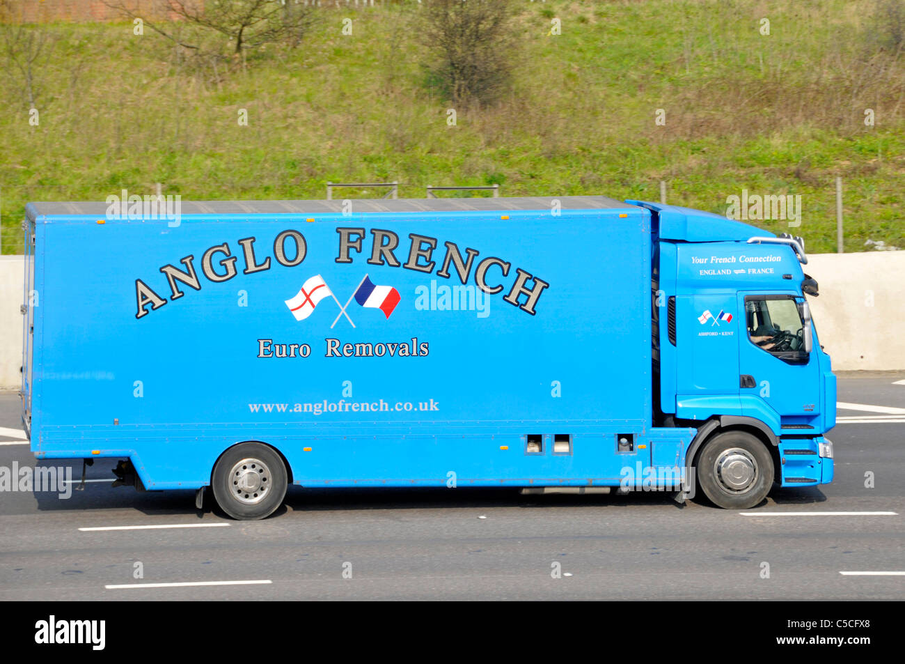 Side view of blue Anglo French Euro removal lorry truck van transport business driving along M25 motorway England UK Stock Photo
