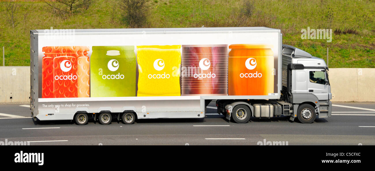 Ocado online internet shopping food grocery supply chain business side view hgv delivery lorry truck & articulated trailer logo on UK motorway Stock Photo