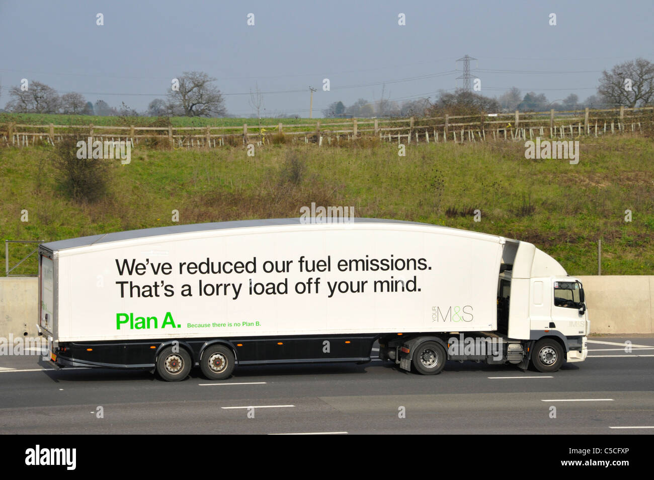 Side view of M&S hgv supply chain distribution delivery lorry truck & aerodynamic shape on articulated trailer Plan A fuel emissions advert on UK road Stock Photo