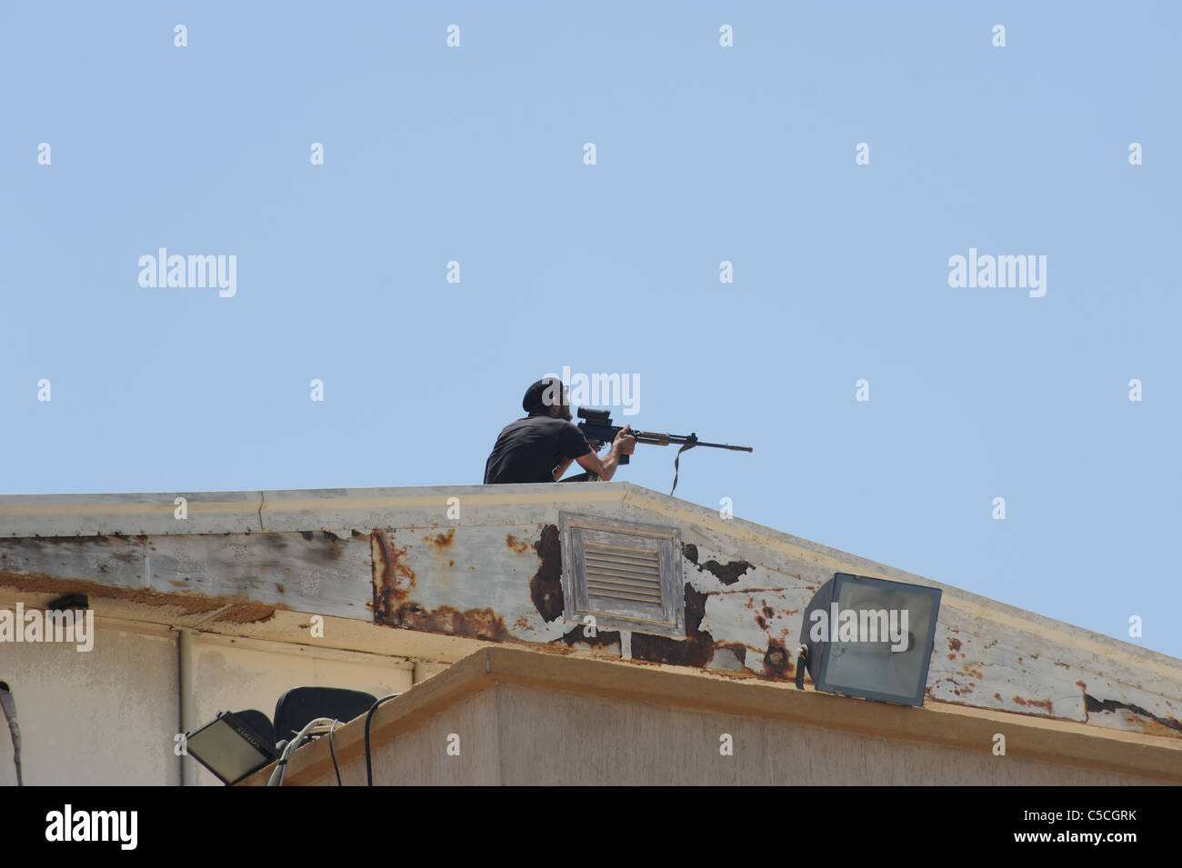 a NTC sniper on the roof of the court house in Benghazi during pares on a Friday he is top cover. Stock Photo