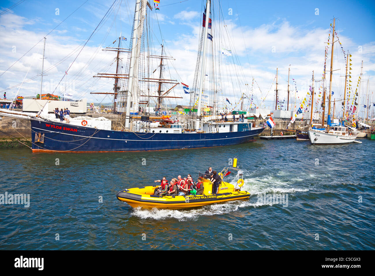Swan Rib Passengers on a Rigid Inflatable Boat (RIB) pass the Wylde Swan in the ...
