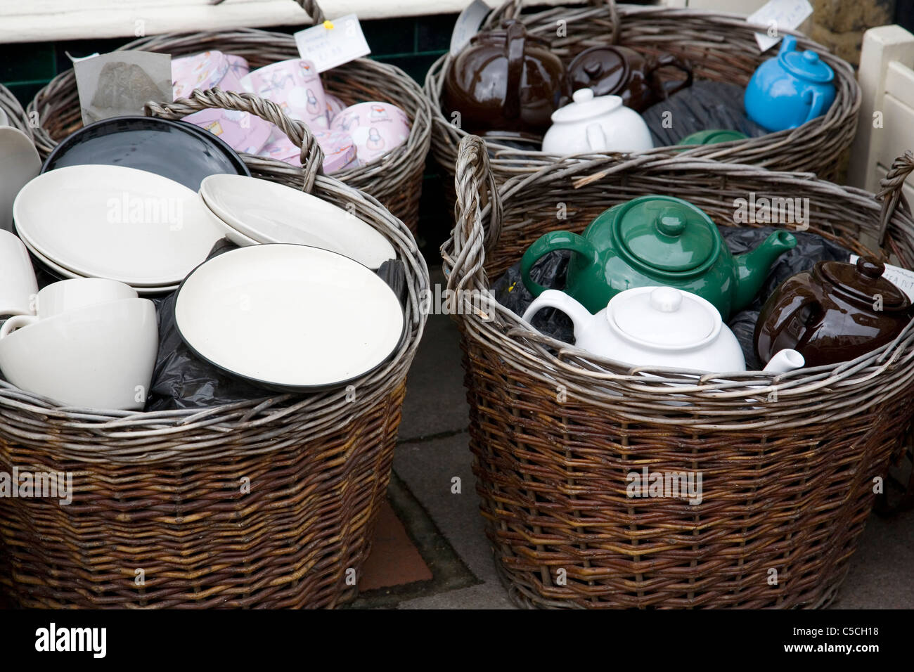 Crockery displayed in baskets for sale Stock Photo Alamy