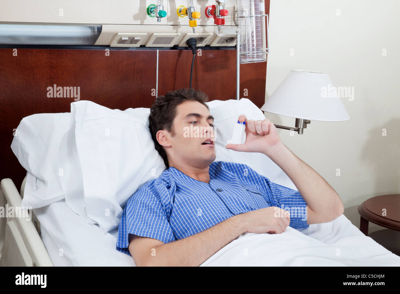 Asthmatic male patient on bed using asthma inhaler Stock Photo Alamy