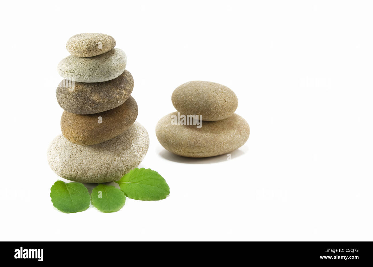 stack of pebbles and leaf on white background Stock Photo - Alamy