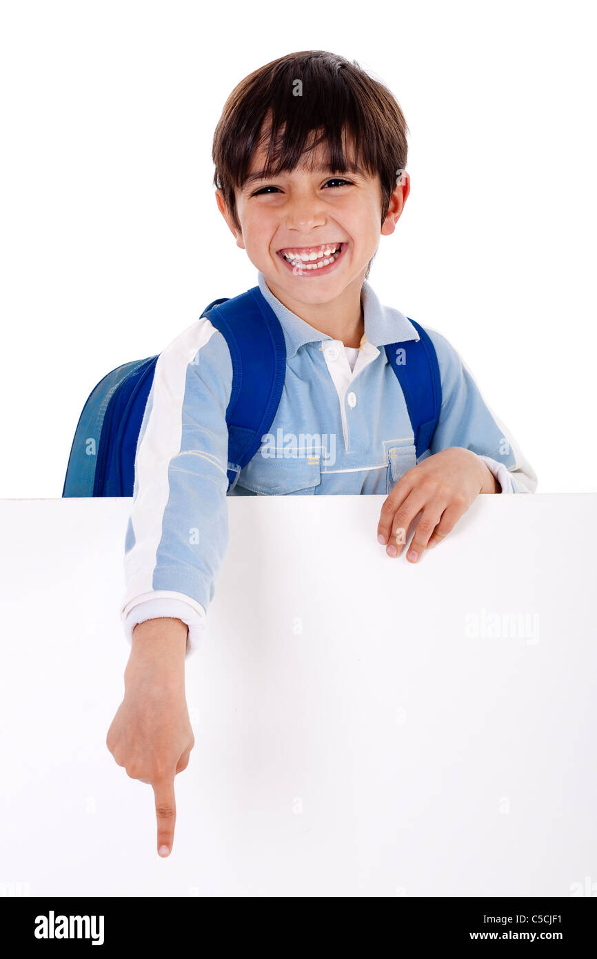 Young school boy showing his finger down from behind the board on white background Stock Photo