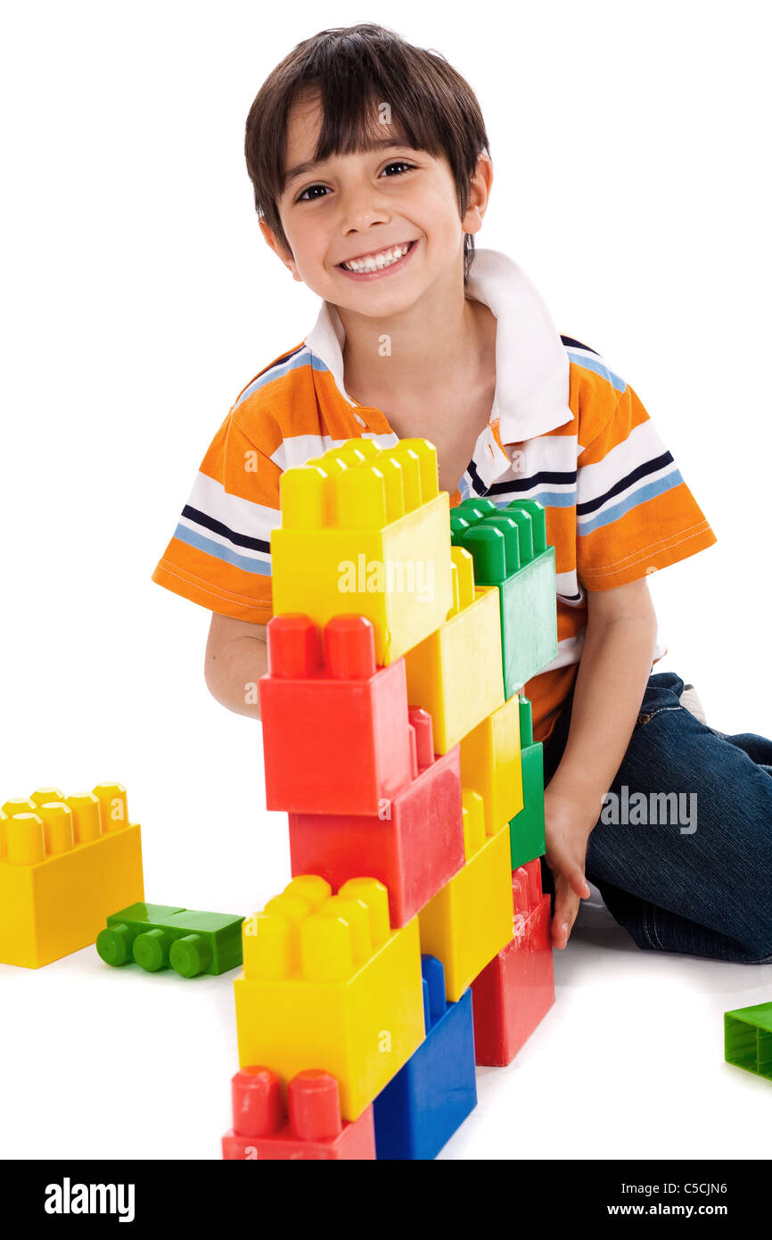 Young boy playing with building blocks on white background Stock Photo