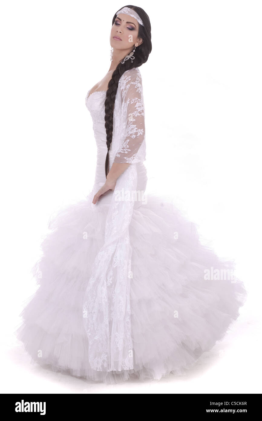 Beautiful lady dressed in wedding costume over white background Stock Photo