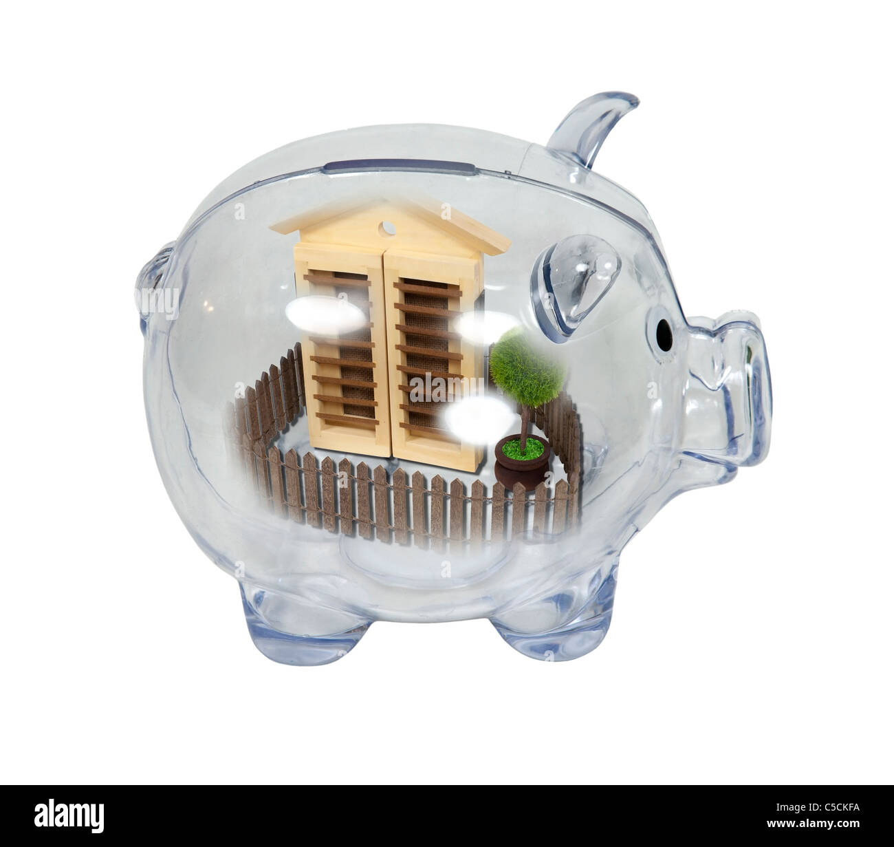 Home savings shown by a piggy bank with a house with picket fence ...