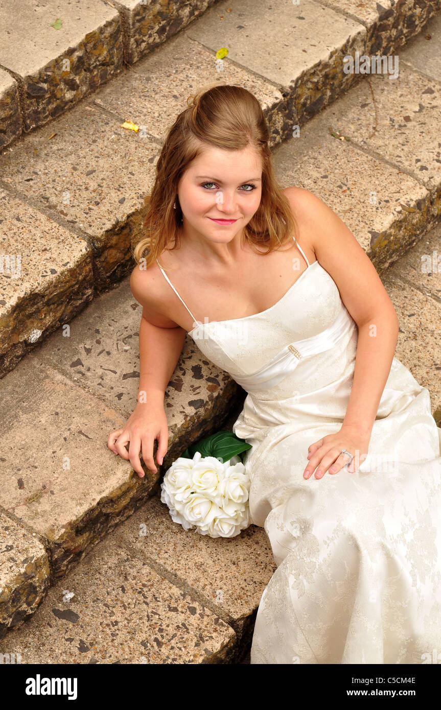 A pretty white bride is waiting outdoors Stock Photo