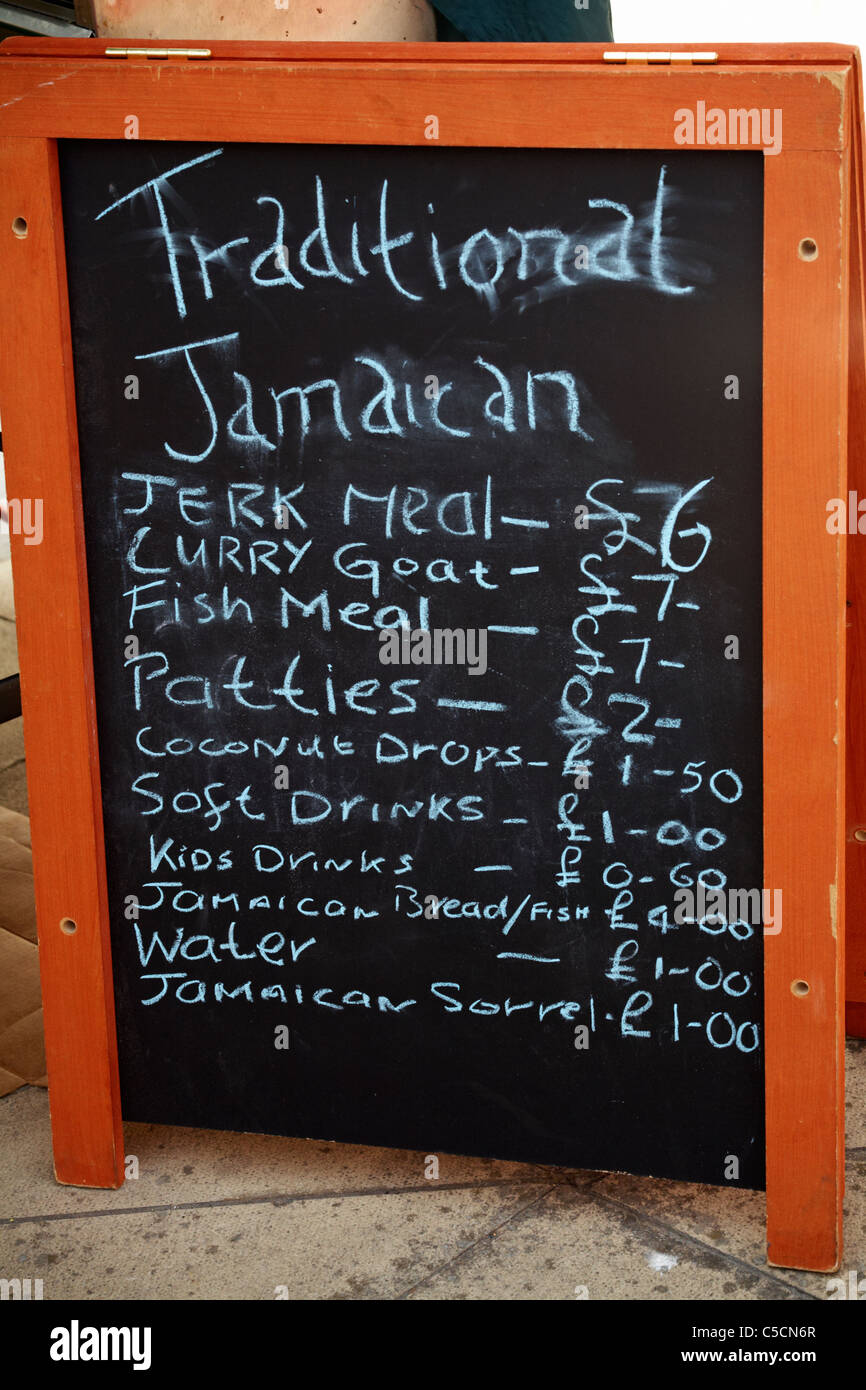 Blackboard advertising Traditional Jamaican foods with prices at the Old Gaffers Festival, Yarmouth, Isle of Wight, Hampshire UK in June Stock Photo