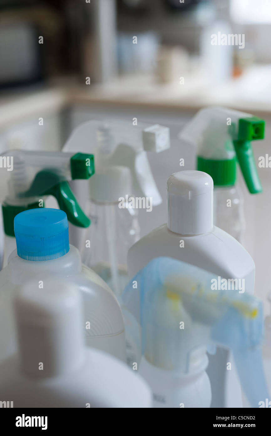 Collection of bottles containing different chemical cleaners in a domestic kitchen environment. Stock Photo