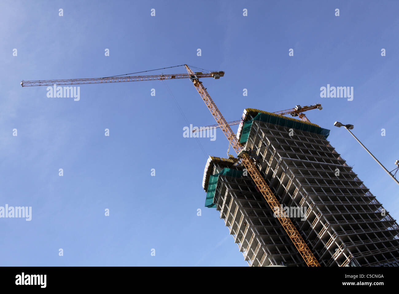 Cranes and building of high-rise in progress, Hamburg Stock Photo - Alamy