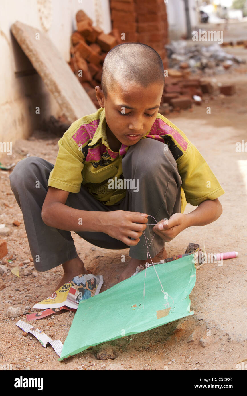 Indian Child playing with a kite in street Stock Photo