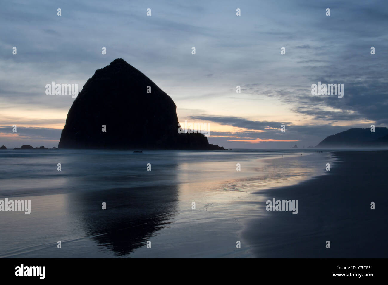 Haystack Rock on Cannon Beach at Oregon Coast after Sunset Stock Photo