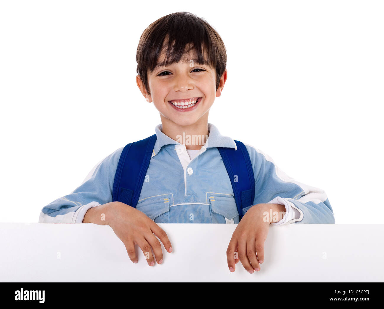 Smiling young boy behind the blank board on isolated white background Stock Photo