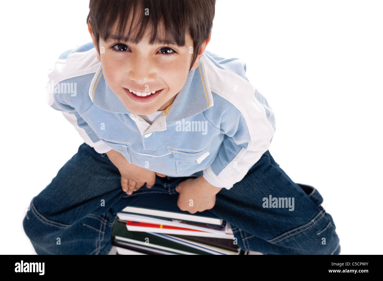 Top angle image of kid sitting on books Stock Photo