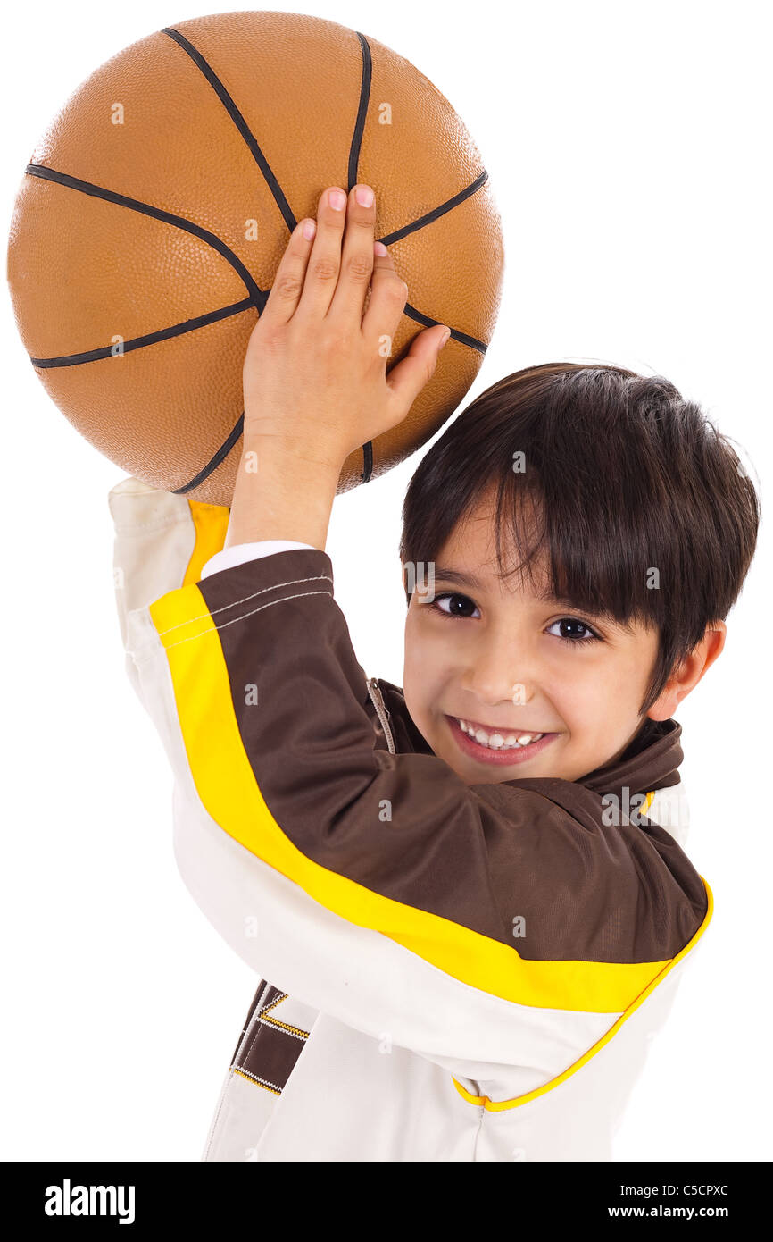 Little kid while throwing the ball on white isolated background Stock Photo