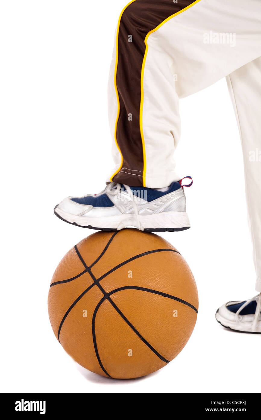 A small kid leg over the ball on isolate white background Stock Photo