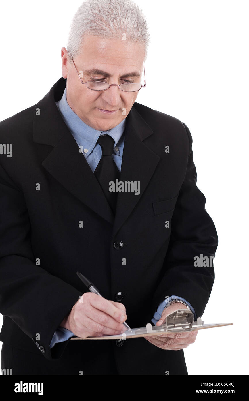 Confident senior business man writing on the clipboard over white ...