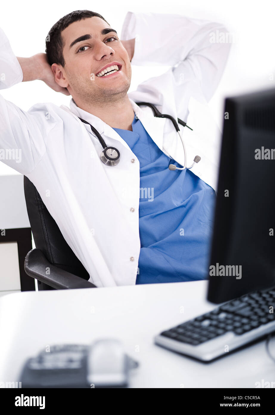 Smiling young male doctor over white background Stock Photo