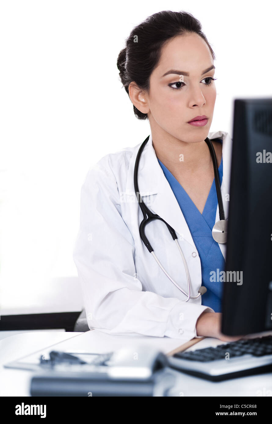 Portrait of beautiful young doctor working in white background Stock Photo