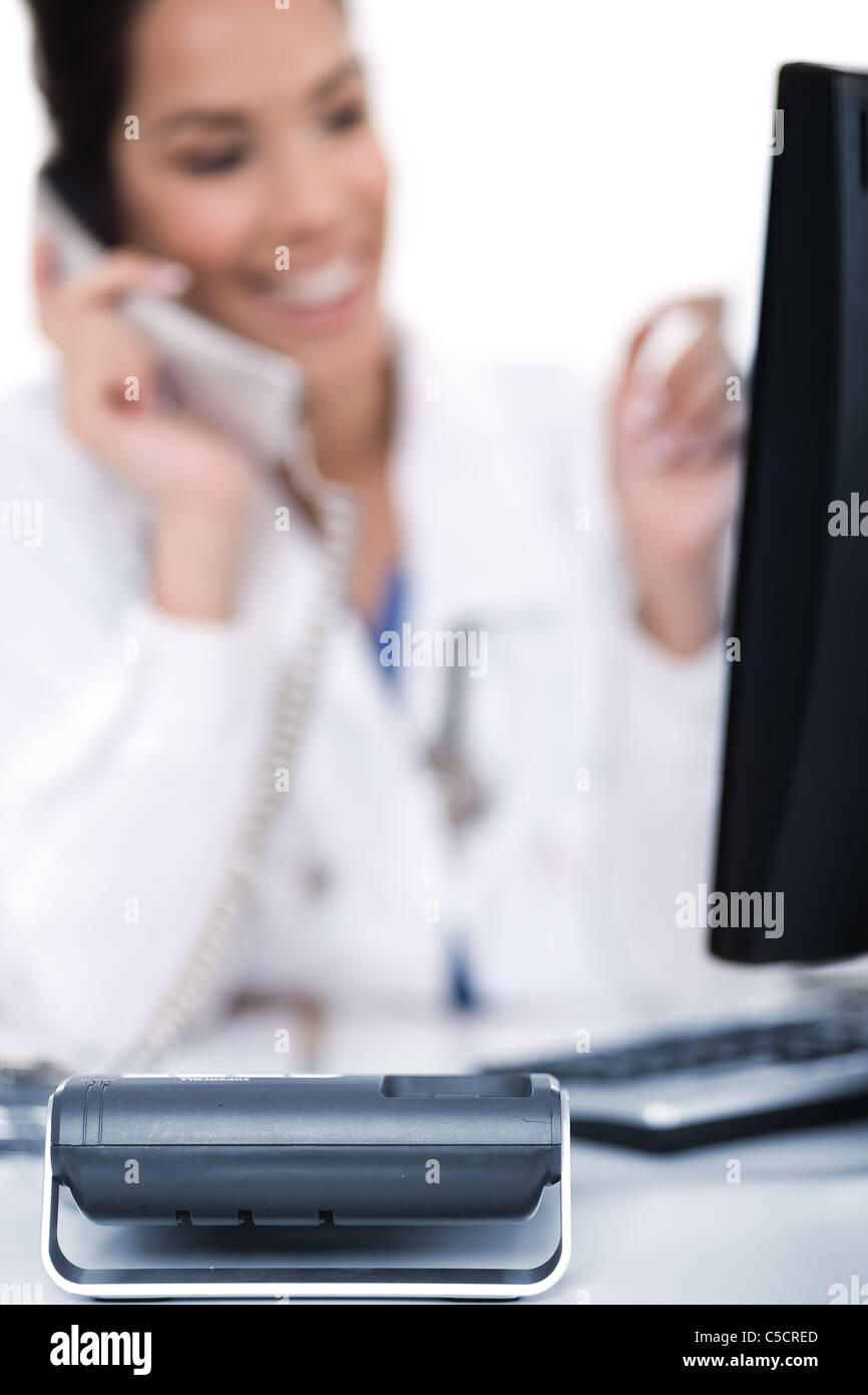 Telephone of focus, doctor talking with it over white background Stock Photo