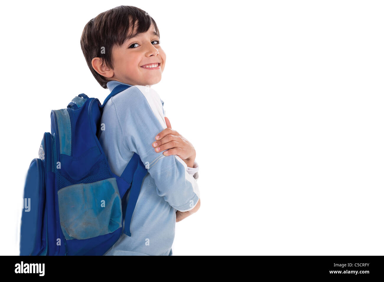 Happy young boy ready for school with his bag on isolated white ...