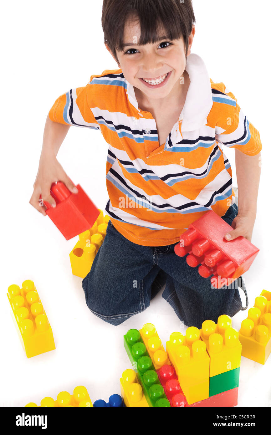 Young boy playing with building blocks on white background Stock Photo