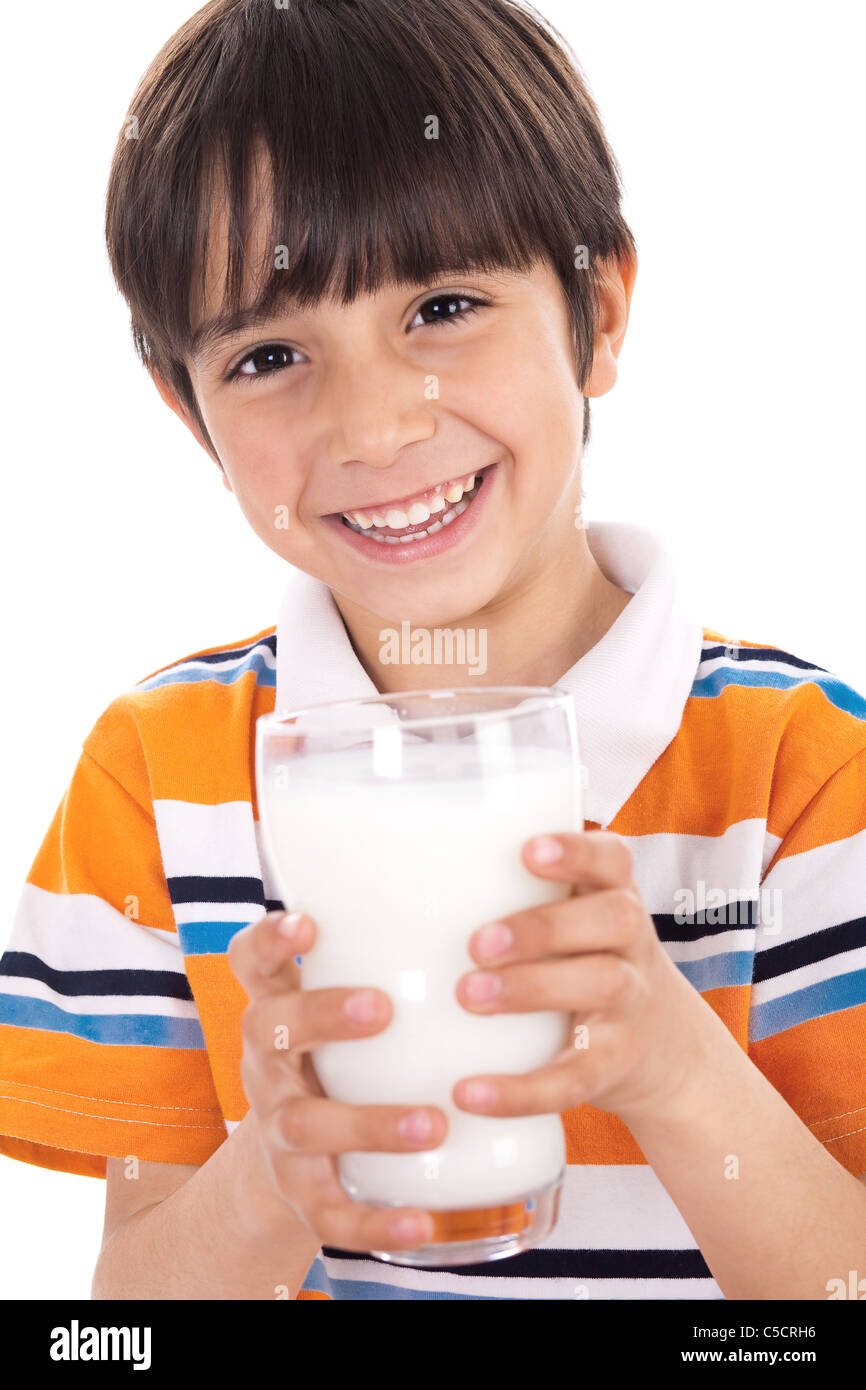 Happy kid holding a glass of milk on isolated background Stock Photo
